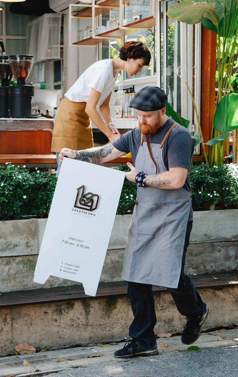 coworkers preparing cafeteria for opening in street