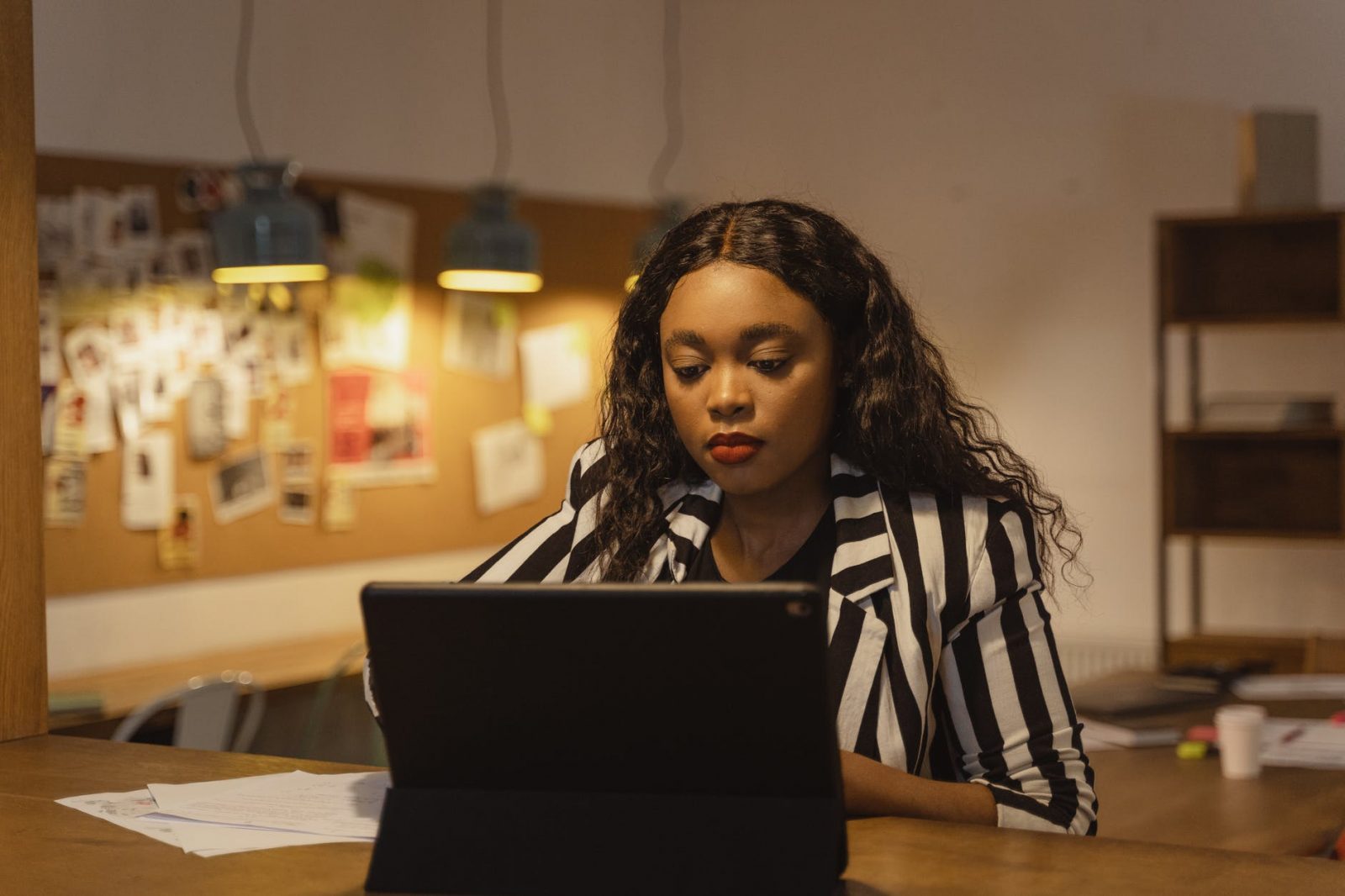 woman in black and white stripe long sleeve shirt sitting at the table